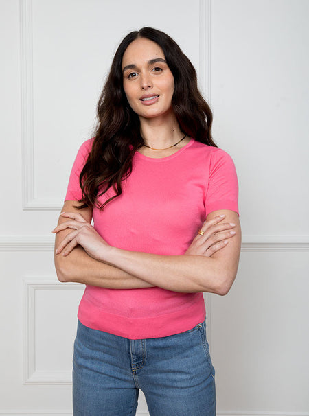 Woman wearing flamingo pink short sleeved knit top in premium and luxury sea island cotton.